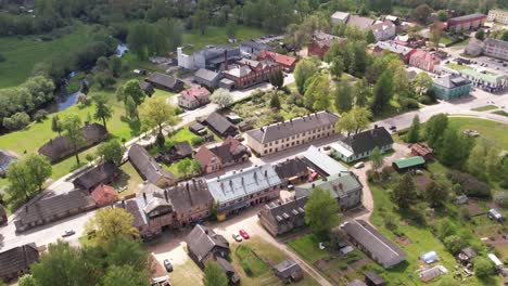 A-stunning-aerial-view-of-Rujiena-city,-showcasing-its-charming-buildings,-streets,-and-lush-greenery