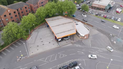 Aerial-orbital-view-of-Sainsburys-petrol-station-in-Bridgwater,-highlighting-the-fueling-area,-building,-and-adjacent-roads,-Bridgwater,-United-Kingdom,-July-2024