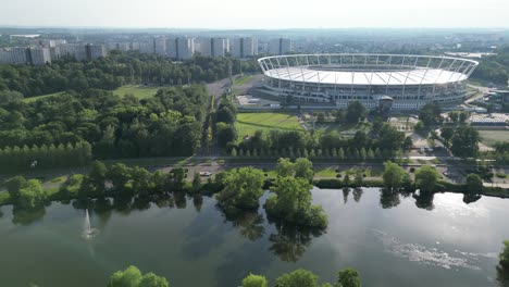 Estadio-De-Silesia-En-Un-Parque-Durante-Un-Día-De-Verano-Rodeado-De-Exuberante-Vegetación-Y-Césped---Drone-4k