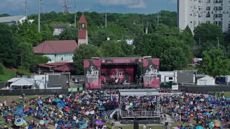 Aerial-approaching-shot-of-Jazz-Festival-in-Atlanta-City-with-crowd-of-fans-in-summer