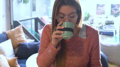 Pretty-female-dressed-in-a-glittery-pink-sweater,-is-engrossed-in-a-book