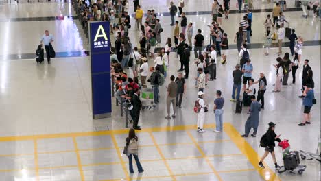 After-landing-at-Chek-Lap-Kok-International-Airport-in-Hong-Kong,-passengers-proceed-to-the-arrival-hall