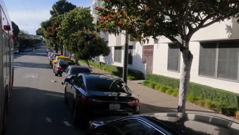 Driving-in-Bus-on-Hilly-Street-in-Residential-Neighborhood-of-San-Francisco,-California-USA,-Out-of-Window-POV