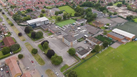 Drone-view-of-Bridgwater-College-Academy-in-Bridgwater,-United-Kingdom,-capturing-the-school-campus,-sports-fields,-and-nearby-residential-areas,-July-2024