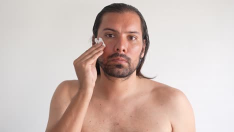 Hombre-Haciendo-Skincare-Para-Cuidar-Su-Rostro,-Hombre-Latino,-Hombre-Barbudo,-Limpieza-E-Hidratacion-De-Rostro-Y-Nariz,-Rutina