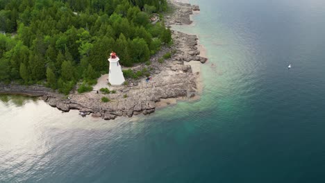 Big-Tub-Lighthouse-drone-ascending-view,-Tobermory,-Canada