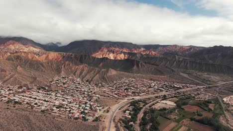 Top-angle-drone-shot-of-Tilcara,-Jujuy-province,-Argentina,-surrounded-by-Quebrada-de-Humahuaca