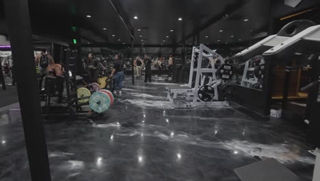 Among-a-gym-filled-with-committed-fitness-enthusiasts-immersed-in-their-workout-routines