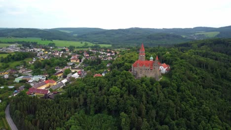 Bouzov-Castle-Overlooking-Village:-Aerial-View-of-Historic-Site-and-Surrounding-Czech-Countryside