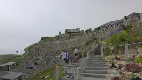 Static-shot-of-tourists-walking-through-the-beautiful-Minack-Theater