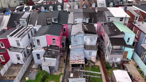 Low-in-coming-houses-with-small-yard-and-old-rusty-roofs-in-suburbia-of-american-town