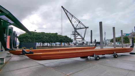 Traditional-Māori-waka-canoe-outside-Te-Wharewaka-o-Pōneke-building-in-Wellington,-New-Zealand-Aotearoa