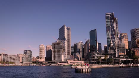 Wide-shot-of-Circular-Quay-and-city-skyline,-on-a-sunny-day,-Sydney-Harbour