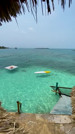 Woman-relaxes-on-a-floating-platform-in-the-crystal-clear-waters-off-the-coast-of-Cartagena