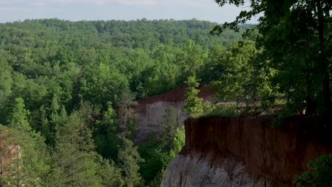 Hiker-looking-over-fence-at-Providence-Canyon-State-Park-in-Georgia