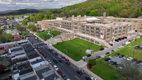 Fast-aerial-shot-past-large-American-city-public-high-school