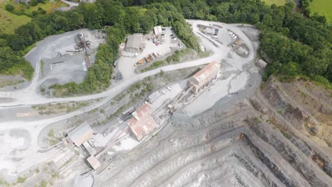 Aerial-fly-in-view-of-an-extensive-aggregate-quarry-and-surrounding-industrial-buildings