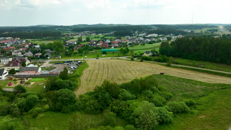 Aerial-view-of-a-village-with-houses-and-buildings-surrounded-by-green-fields-and-trees