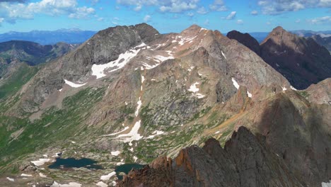 Top-of-summit-Sunlight-Windom-Peak-Mount-Eulos-North-Twin-Lakes-trail-Colorado-Chicago-Basin-morning-sunny-clouds-spring-summer-fourteener-July-Needle-San-Juan-Rocky-Mountains-slow-pan-left-motion