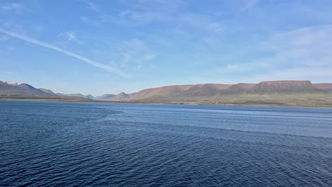 Ocean-and-mountains-as-a-cruise-ship-approaches-Akureyri,-Iceland