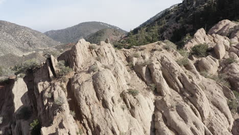 Rocky-formations-and-green-hills-create-a-unique-geographical-landscape-in-Devil's-Punchbowl