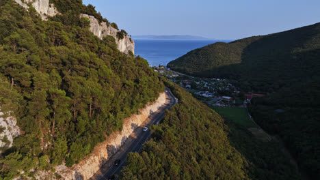 Drone-flying-parallel-to-a-mountainside-road-on-the-coast-of-Istria,-in-Croatia