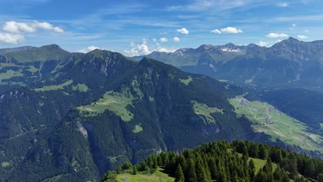 Spectacular-aerial-panoramic-view-of-green-mountain-peaks-in-Switzerland