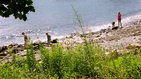 People-exploring-rocky-beach-at-Fort-Wiliams-Park-Cape-Elizabeth,-Maine