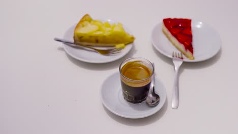 Cheesecake-dessert-and-black-coffee-on-bright-white-indoor-surface,-Malorca