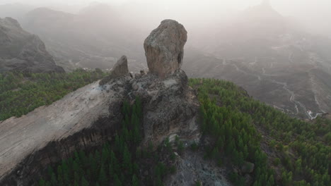 Aerial-view-in-orbit-over-the-famous-Roque-Nublo-during-sunset