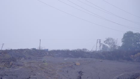 Coal-mine-with-smoke-and-burning-embers-coming-from-the-underground-coal-field-fire-in-Jharia,-Jharkhand,-India