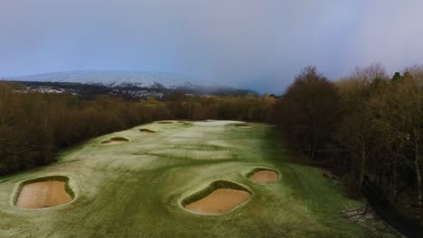 Golf-Course-Aerial,-Drone-Flight-over-Beautiful-Hole-Surrounded-by-Forest-in-the-Scottish-Highlands