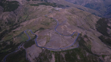 Wide-aerial-footage-of-a-long-circuitous-road-in-the-mountains-south-of-Cusco,-Peru