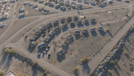 Houses-clustered-together,-barren-land,-aerial-drone-view