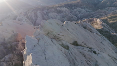 A-drone-captures-the-breathtaking-landscape-of-Devil's-Punchbowl,-showcasing-the-rugged-beauty-of-the-rock-formations-and-the-vast-expanse-of-the-surrounding-desert