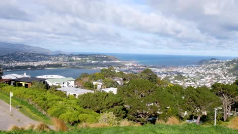 Scenic-landscape-view-from-Mt-Vic-lookout-over-airport,-suburbs-of-Kilbirnie-and-Lyall-Bay-and-ocean-in-capital-city-of-Wellington,-New-Zealand-Aotearoa