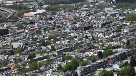 Toma-Aérea-Con-Zoom-De-Una-Ciudad-Estadounidense-Con-Una-Hilera-De-Casas-Y-Una-Iglesia-Durante-Un-Día-Soleado-De-Primavera