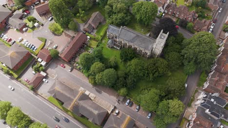 Aerial-view-of-St-John-the-Baptist-Church-in-Bridgwater,-capturing-the-historic-architecture,-lush-greenery,-and-surrounding-neighborhood