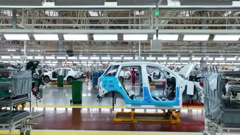 Factory-industrial-Robot-arm-inspecting-an-automobile-assembly-line-works-that-assembles-lithium-or-sodium-batteries-used-in-cars-or-electric-vehicle-Production-Line