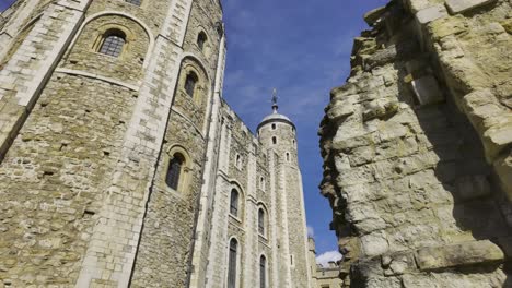 White-Tower-at-the-Tower-of-London-with-the-Roman-City-Wall-ruins-in-the-foreground-in-London,-UK---March-28,-2024