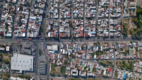 Bird's-eye-view-establishing-in-Lo-Prado-with-low-houses-and-zinc-roofs,-Santiago-Chile