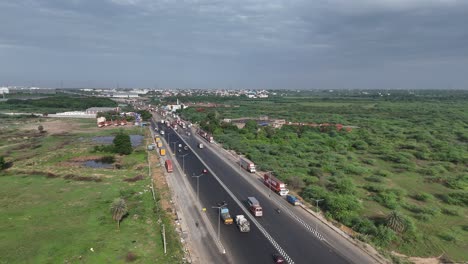 Aerial-footage-view-of-the-Chennai-to-Hosur-highway-at-midday,-with-clear-skies-and-steady-traffic,-showcasing-the-smooth-connectivity-between-the-two-cities