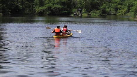 Two-people-paddling-a-kayak-on-a-sunny-day,-enjoying-their-leisure-time-and-an-active-lifestyle-in-Poti,-Georgia