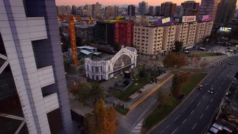 Commemoration-of-the-old-railway-terminal-Providencia-,-sunset-in-Baquedano-square-with-heritage-architecture,-residential-buildings