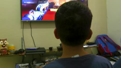 A-young-boy-is-home-playing-video-games-while-talking-to-his-mother-after-school