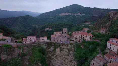 Aerial-toward-small-historic-church-on-cliff-Savoca,-Sicily