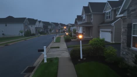 Low-aerial-above-sidewalk-in-foggy-American-neighborhood