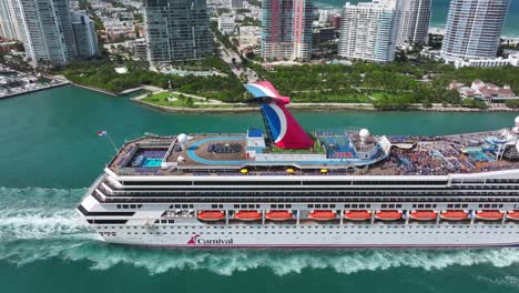 Tourist-on-deck-of-luxury-Carnival-Cruise-Ship-leaving-port-of-Miami-City