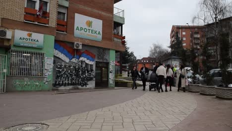 Menschen-Laufen-über-Ein-Serbisch-nationalistisches-Wandbild-In-Nord-Mitrovica