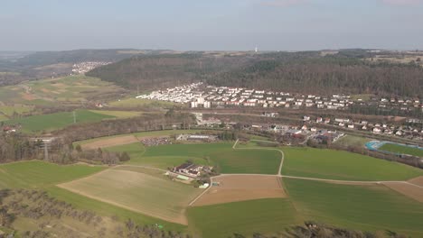 Flyover,-aerial-footage-of-Nagold-area-landscape,-rural-fields-and-farms,-fertile-green-swabian-landscape